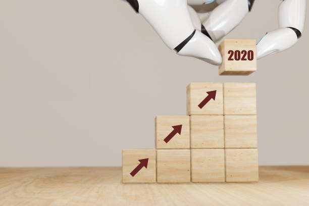 istock 3d rendering artificial intelligence robot hand flip the 2020 wooden cube concept to make growth in business in year 2020 1197931225