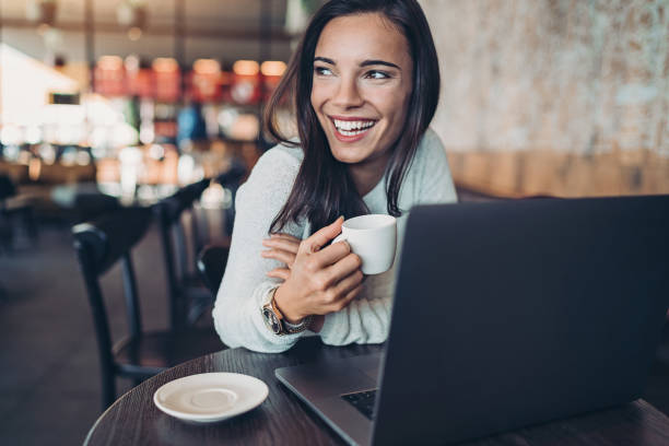 istock Happy young woman in cafe 1197932667