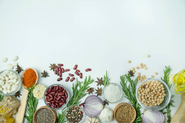 istock Cooking background, herbs, salt, spices, olive oil, white background copy space. View from above. Healthy food concept with fresh vegetables and cooking ingredients. Table background menu. 1197933285