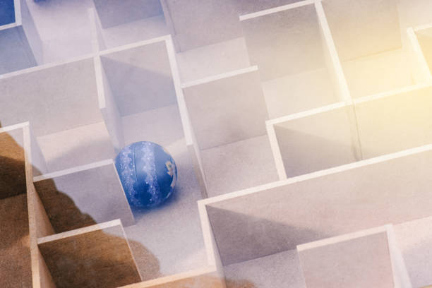 istock Labyrinth with a ball. Wooden large maze and blue ball. Search for a solution and exit from the maze. Educational game 1197933476