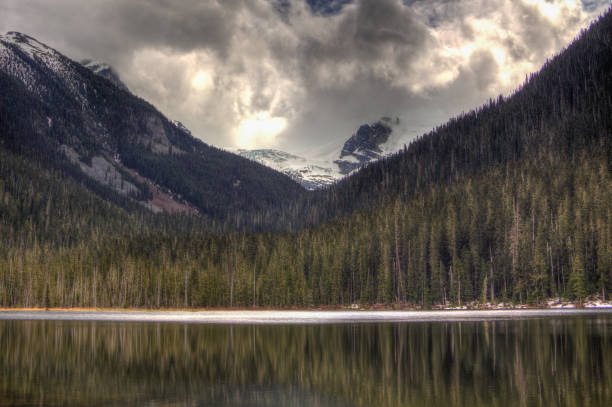 istock Snowy mountains with a lake at the bottom and cloudy sky 1197933551
