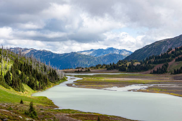 istock Snowy mountains with a lake at the bottom and cloudy sky 1197933560