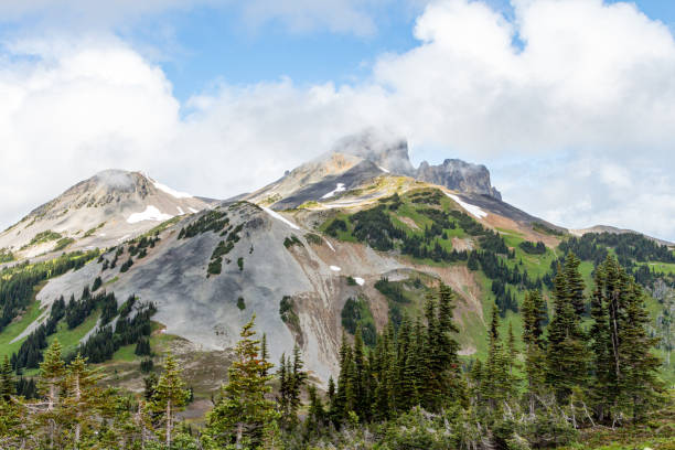 istock Snowy mountains with a lake at the bottom and cloudy sky 1197933576