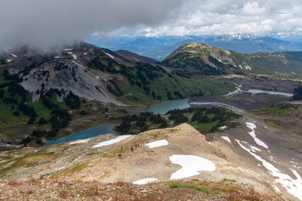 istock Snowy mountains with a lake at the bottom and cloudy sky 1197933587