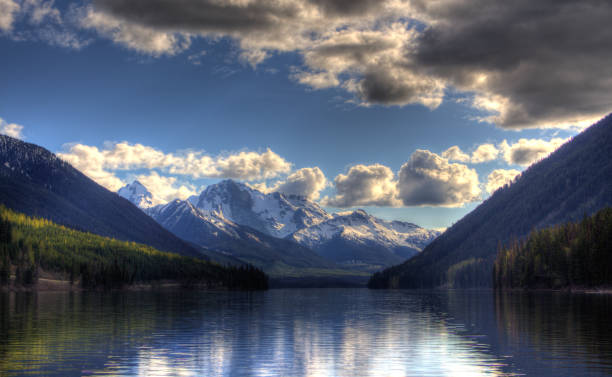 istock Snowy mountains with a lake at the bottom and cloudy sky 1197933592