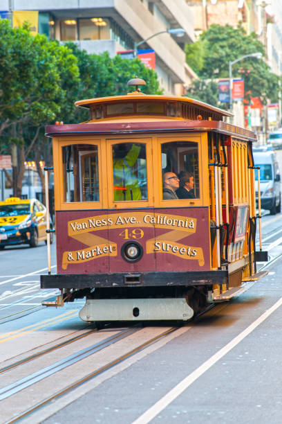 San Francisco, United states of america - december 12, 2013: Passengers enjoy a ride in a cable car on Dec 16, 2013 in San Francisco. It is the oldest mechanical public transport in San Francisco which is in service since 1873.