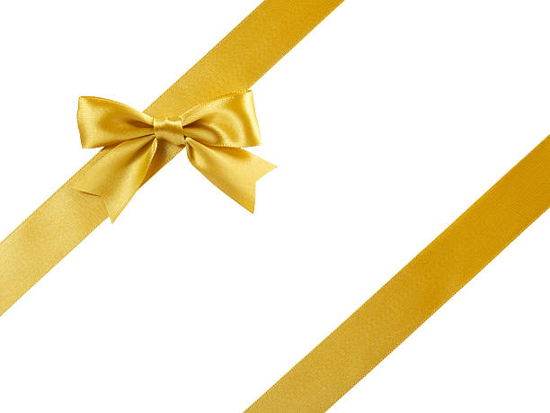 single golden satin gift bow with oblique ribbon on white stock photo