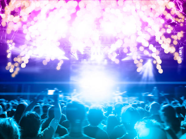 istock Concert stage, people are visible waving and clapping, silhouettes are visible 1197943151