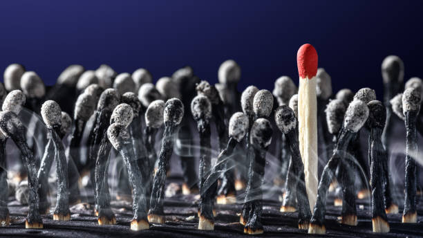 istock Burnt Matchsticks With One Survivor 1197943302