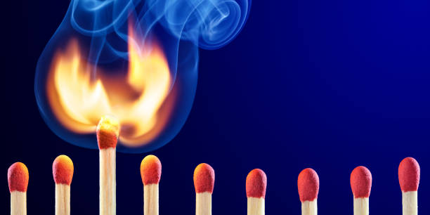 istock Row Of  Matchsticks With One Bursting Into Flames 1197943914