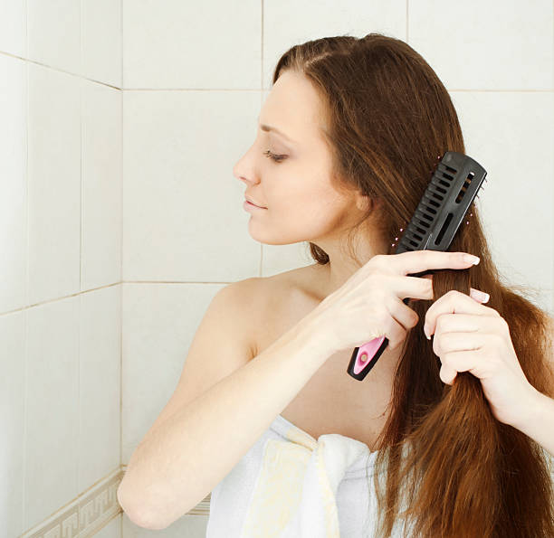 istock Young brunette lady combing her beautiful long hair 119794396