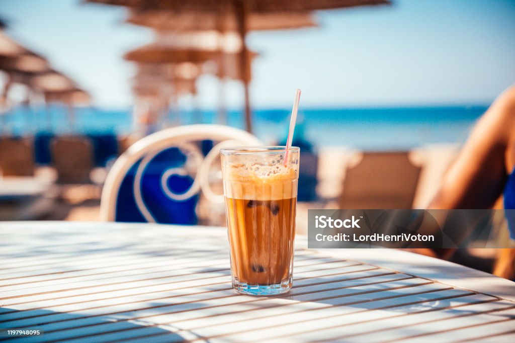 Coffee Frappe on table Coffee Frappe on table perfect refreshment on summer sea vacation Beach Stock Photo