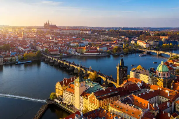 Photo of Aerial Prague panoramic drone view of the city of Prague at the Old Town Square, Czechia. Prague Old Town pier architecture and Charles Bridge over Vltava river in Prague at sunset, Czech Republic.