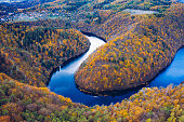 Beautiful Vyhlidka Maj, Lookout Maj, near Teletin, Czech Republic. Meander of the river Vltava surrounded by colorful autumn forest viewed from above. Tourist attraction in Czech landscape. Czechia.
