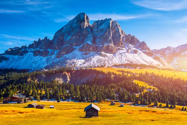 Stunning view of Peitlerkofel mountain from Passo delle Erbe in Dolomites, Italy. View of Sass de Putia (Peitlerkofel) at Passo delle Erbe, with wooden farm houses, Dolomites, South Tyrol, Italy.