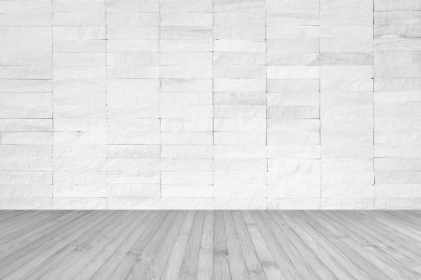 istock White brick wall with wooden floor textured background in light grey color 1197951263