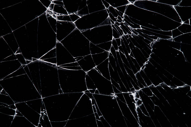 istock cracked glass isolated on a black background. 1197951314