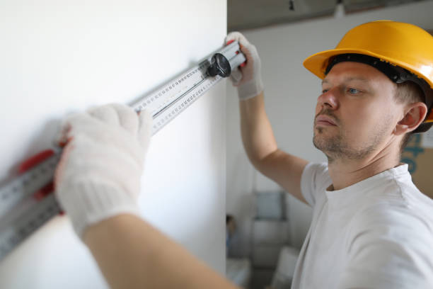 istock Male worker in yellow helmet hold building 1197951339