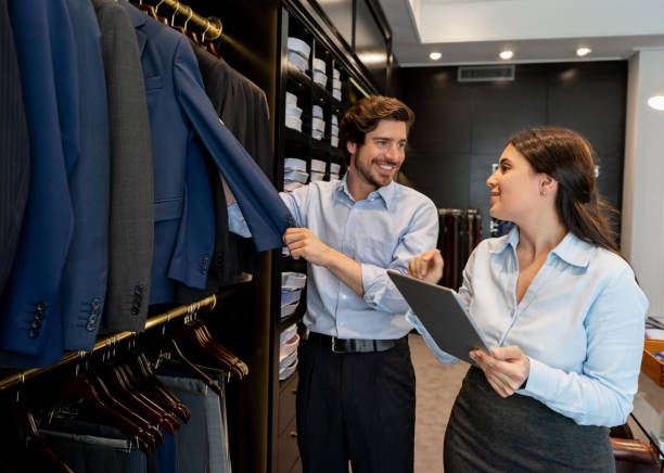istock Handsome male customer talking to friendly sales qoman holding a tablet 1197952577