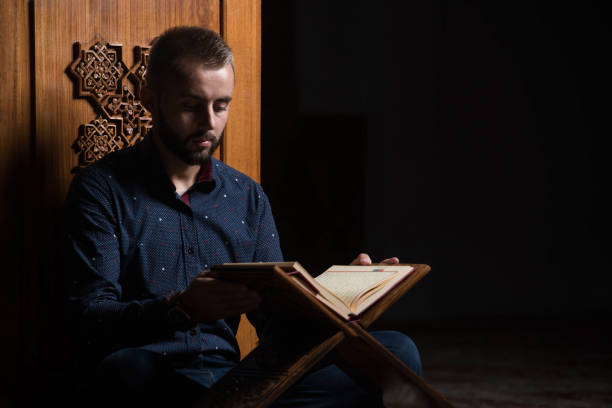 istock Young Muslim Guy Reading The Koran 1197953588