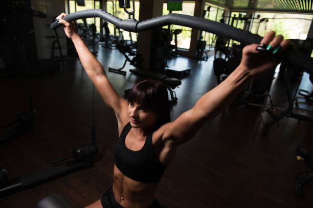istock Attractive Woman Doing Heavy Weight Exercise For Back 1197953633