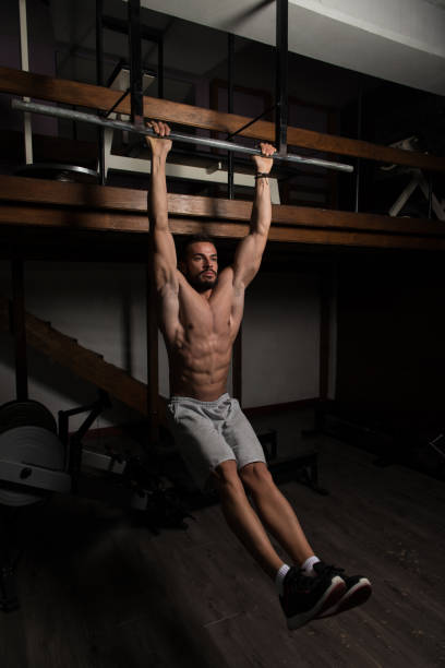 istock Athlete Performing Hanging Leg Raises Exercise Ab Exercises 1197953642