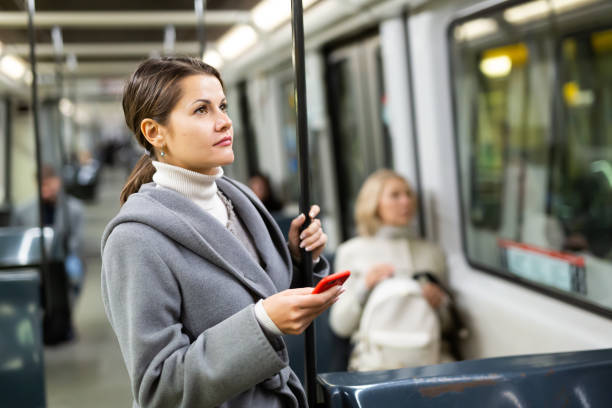 istock Positive woman reading from mobile phone screen in tram 1197954943