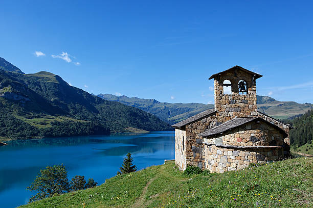 istock chapel, lake and mountains 119795623