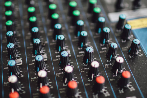 istock Musical control panel with sliders. Analog sound mixer or console. Remote control microphones and musical instruments.Buttons and tabs in various parts of the audio controller 1197960498