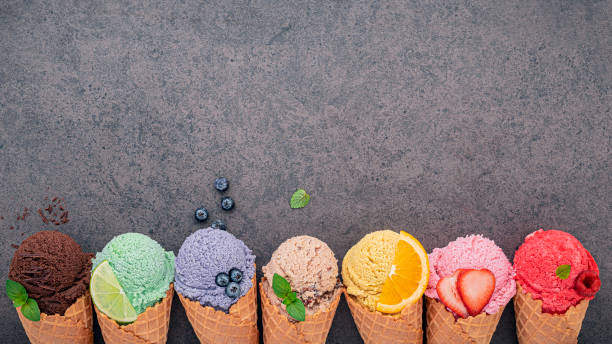 istock Flat lay ice cream cones collection on dark stone background . Blank crispy ice cream cone with copy space for sweets menu design. 1197964441