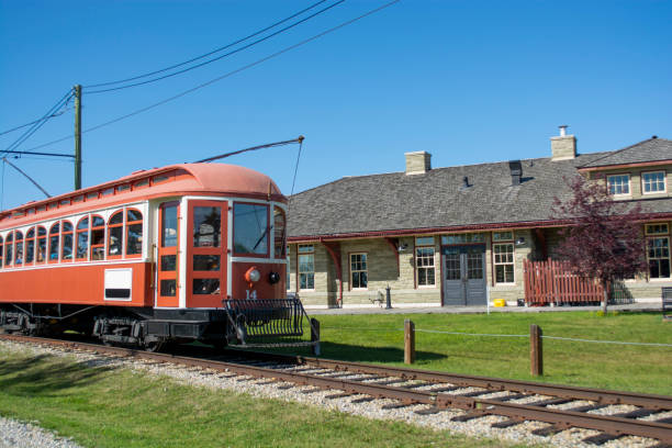istock Historic trolley transit train beside train station 1197971063
