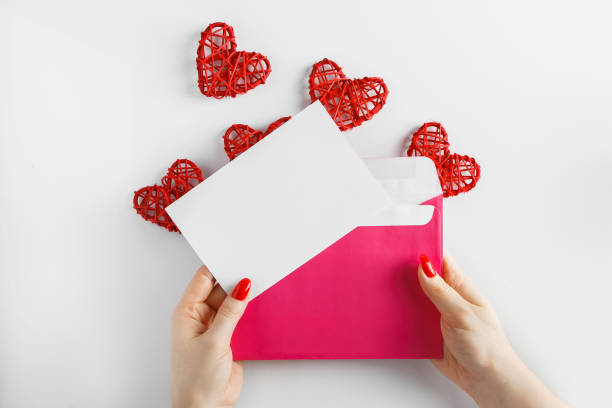 istock Envelope with a letter in hands on a white background. 1197975573