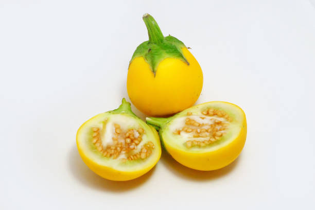 istock Yellow eggplant slice isolated. Freash eggplant Thai or aubergine vegetable on white background texture. Food and drink design. 1197979094