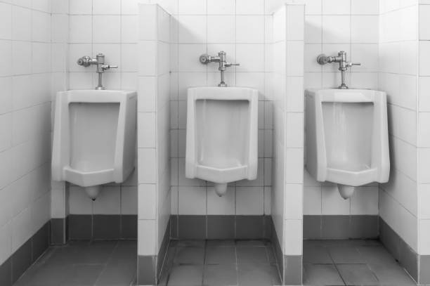 urinals sanitary in toilet room urinals sanitary in toilet room, black and white tone, industry construction background flushing valve public restroom toilet stock pictures, royalty-free photos & images