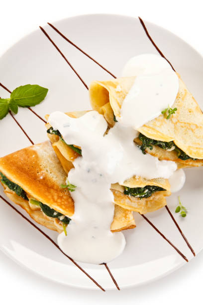 istock Crepes with spinach and cream on white background 1197983548