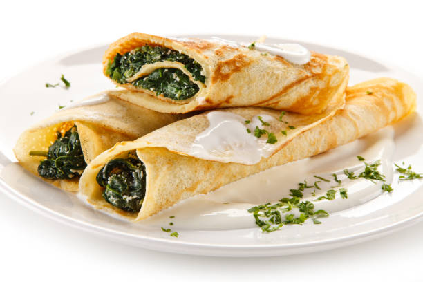 istock Crepes with spinach and cream on white background 1197983561