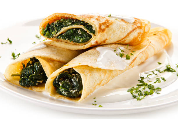 istock Crepes with spinach and cream on white background 1197983568