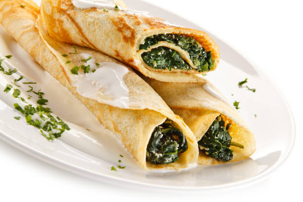 istock Crepes with spinach and cream on white background 1197984084