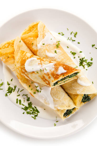istock Crepes with spinach and cream on white background 1197984093