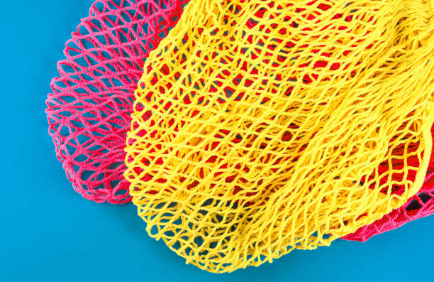 istock Zero waste. Color mesh shopping bags on blue 1197988227