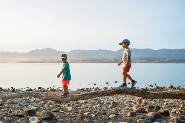 istock Kids walking on log trying to balance. 1197988848