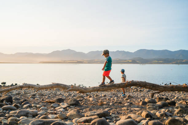 istock Kids playing next to lake. 1197988855