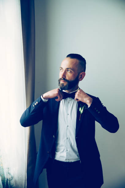 close up. confident man straightening his bow tie. people and events