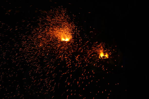 istock Corn being cooked on coal near beach with some fire spark . A corn roaster sparkling fire in the shores of Marina Beach, Chennai, India on night 1197992289