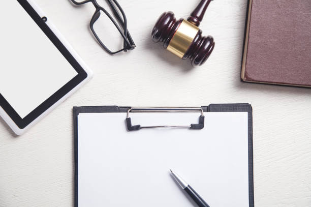 istock Judge gavel with a other objects on a white desk. Law concept 1197995330