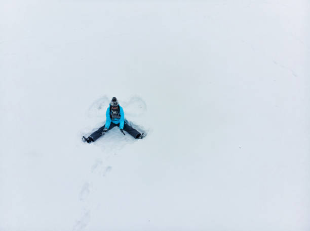 istock overhead view woman making snow angel 1197995943