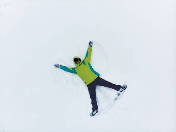 istock overhead view of man making snow angel 1197995946
