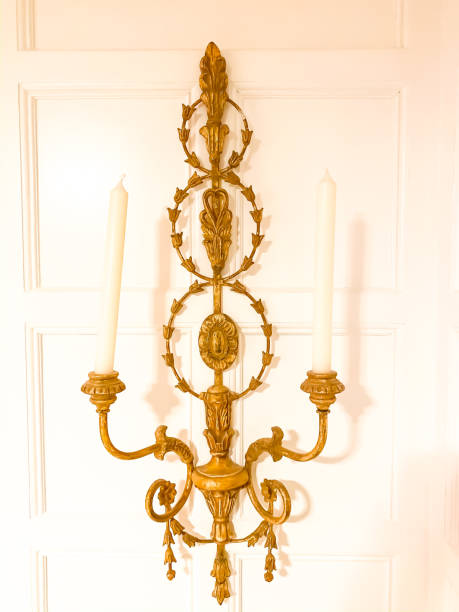 istock Ornate Gold Sconce with Tall White Candlesticks 1197996315