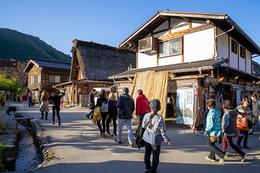 Shirakawa Japan - 12 Nov 2019: Many people walking around traditional Gusso farmhouse at Shirakawa go village in autumn, Japan.