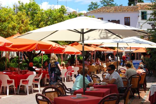 Typical restaurant scene in the South of France with tables and chairs set for early evening customers.